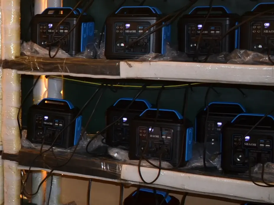 Portable power stations connected by cables on partner testing racks